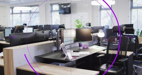 Minimalist open office workstation framed by rotating purple rings, digital overlay labels