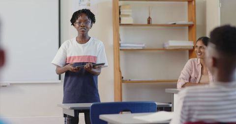 Confident Student Presenting in Classroom with Tablet Technology