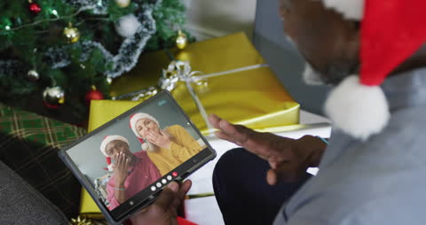 Virtual Christmas Call with Friends in Santa Hats by Tree
