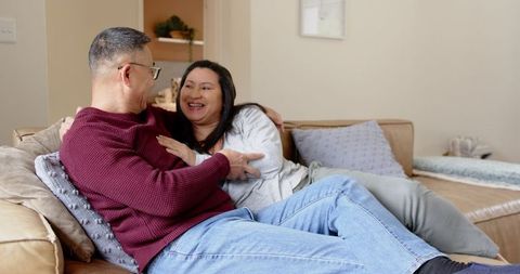 Senior Asian Couple Bonding on Cozy Living Room Sofa