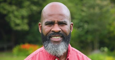 Mature african american man smiling in lush garden setting