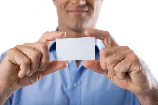 Male executive holding a blank business card against white background