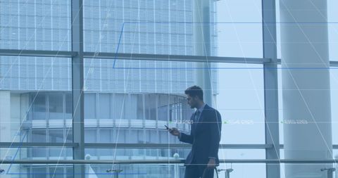 Businessman Analyzing Financial Data in Modern Glass Office