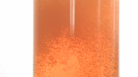 Amber Fizzy Drink Bubbling in Slow Motion