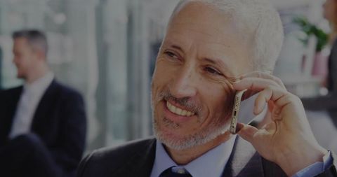 Executive in Corporate Lounge Using Smartphone for Communication