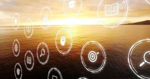 Floating digital icons over sunset seascape with island silhouette