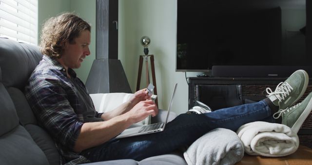 Young Man Shopping Online with Credit Card on Couch at Home - Download Free Stock Images Pikwizard.com