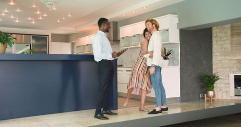 Cheerful couple on house tour with real estate agent