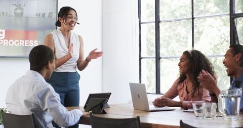 Diverse Team Collaborating and Celebrating Success in Modern Office
