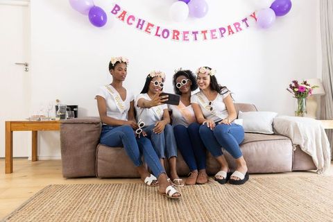 Joyful bachelorette party with friends sitting together