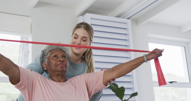 Elderly Woman Exercising with Therapist Using Resistance Band Indoors - Download Free Stock Images Pikwizard.com