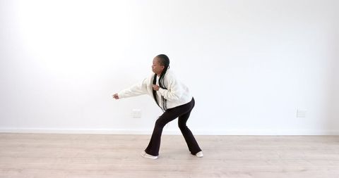 Young Girl Practicing Martial Arts in Minimalist Room