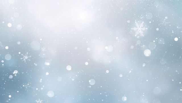 Drifting snowflakes and soft bokeh winter background glowing diffuse top light