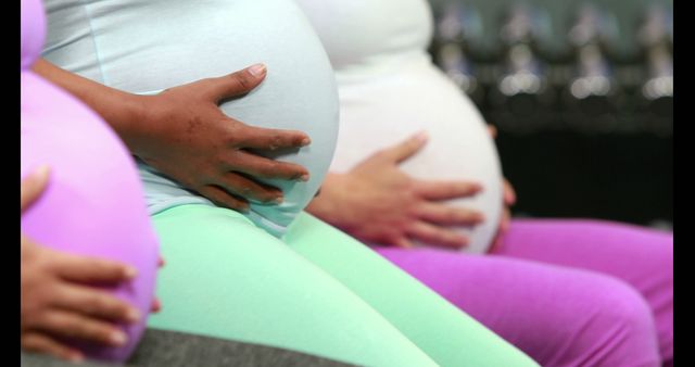 Group of Pregnant Women Sitting Together Holding Their Bellies - Download Free Stock Images Pikwizard.com