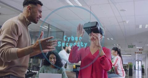 Team exploring cybersecurity with virtual reality headset in modern open-plan office