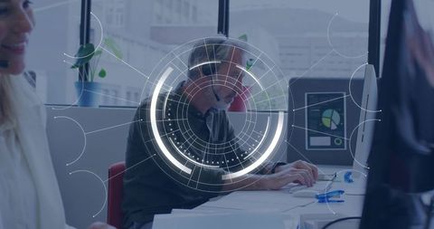 Contact center agent typing with headset amid hud data overlay and collaborative dashboard