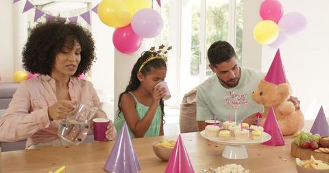 Family Birthday Celebration with Cupcakes and Colorful Decorations