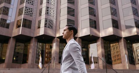 Confident young businessman walking in urban environment