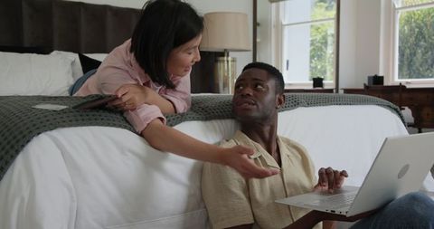 Couple Relaxing at Home with Laptop and Smartphone