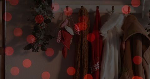 Cozy winter coats and christmas decorations with festive bokeh