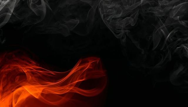 Dynamic red and grey smoke swirling on black background