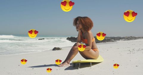 Woman Relaxing on Beach Surrounded by Love Emojis