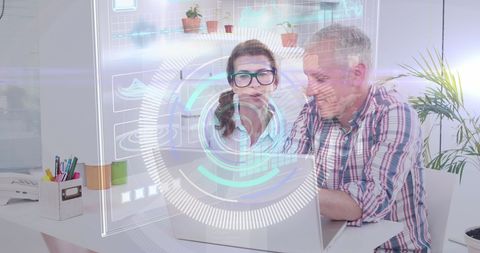 Designers discuss with futuristic tech interface in office