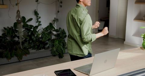 Professional Gesturing in Modern Office Near Desk with Laptop