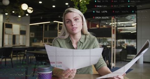 Caucasian businesswoman analyzing financial data patterns in modern office