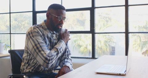 Businessman discussing project on laptop communicating remotely