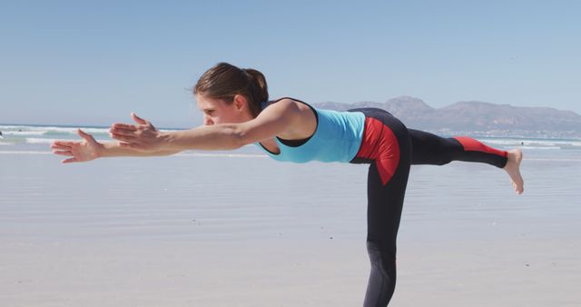 Woman Practicing Yoga on Beach in Warrior Pose - Download Free Stock Images Pikwizard.com