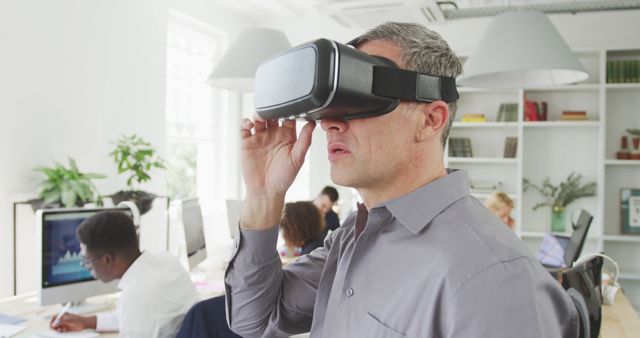 Professional man using virtual reality glasses in modern office environment - Download Free Stock Images Pikwizard.com