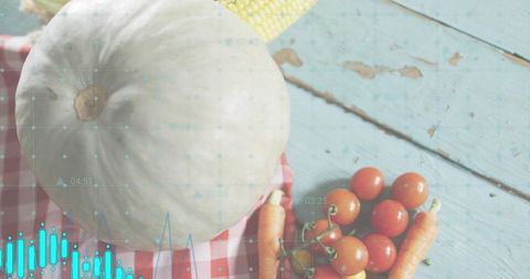 White pumpkin and fresh produce on rustic turquoise table with digital data overlay