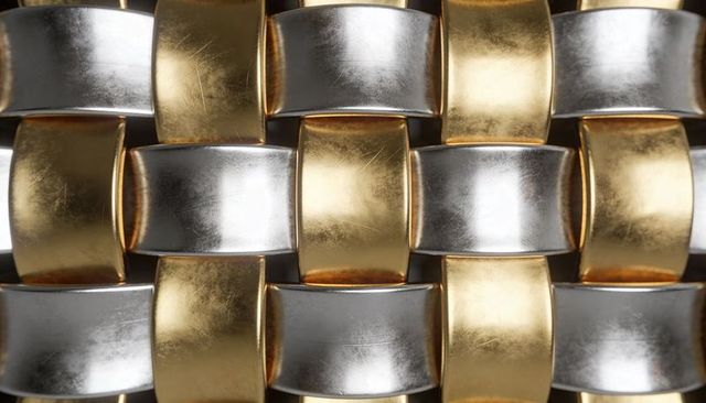 Interlocking gold and silver metal weave showing macro two-tone reflective texture