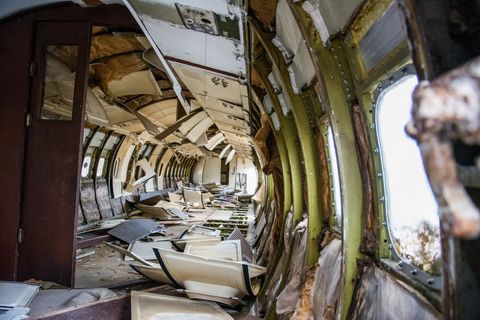 Abandoned plane crash interior with wreckage and debris