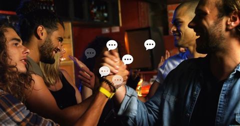 Clasping hands celebrating friendship at lively bar with chat bubble overlays