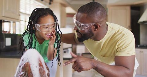 Father and daughter exploring science with homemade volcano experiment