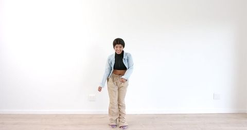 Young Girl Expressing Joy Through Dance in Casual Indoor Setting - Download Free Stock Images Pikwizard.com