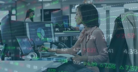 Businesswoman Analyzing Financial Data on Office Computer Screen