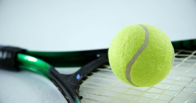 Close-up Tennis Ball Resting on Racket - Download Free Stock Images Pikwizard.com