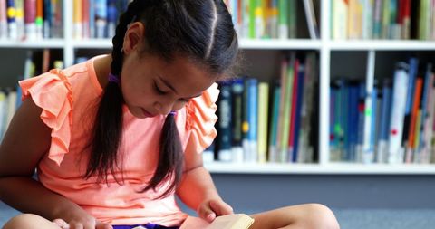 Young girl reading book in a cozy library