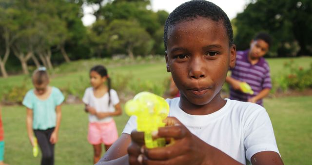 Children Playing with Water Guns in Park - Download Free Stock Images Pikwizard.com