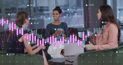 Businesswomen Analyzing Financial Charts in Office Lounge