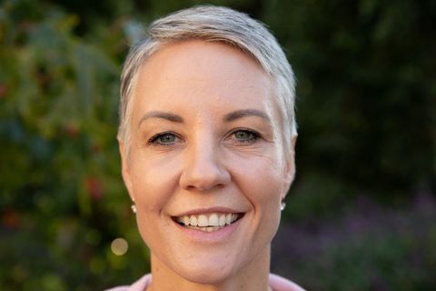 Senior Woman Smiling with Elegance in Vibrant Outdoor Setting