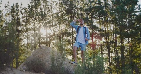 Young Man Hiking in Forest During golden Hour