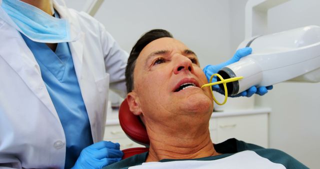 Mature Dentist Checking X-rays on Patient - Download Free Stock Images Pikwizard.com