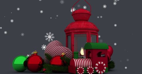 Colorful holiday display featuring red ornament balls and checked fabric hearts surrounding a classic red metal lantern. Lantern softly lit for cozy and welcoming ambiance, set against a black background with digitally generated snowflakes. Suitable for festive Christmas cards, seasonal social media posts, and winter-themed promotional materials where warmth and tradition are desired.