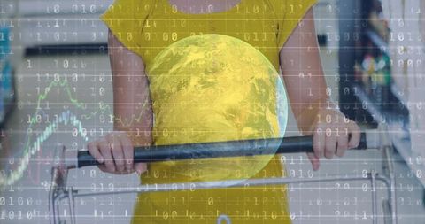 Shopper holding cart in yellow dress with digital globe overlay representing retail data