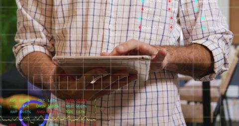 Professional Analyzing Data on Digital Tablet