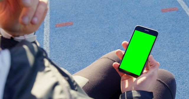 Person Using Smartphone with Green Screen at Track Field - Download Free Stock Images Pikwizard.com